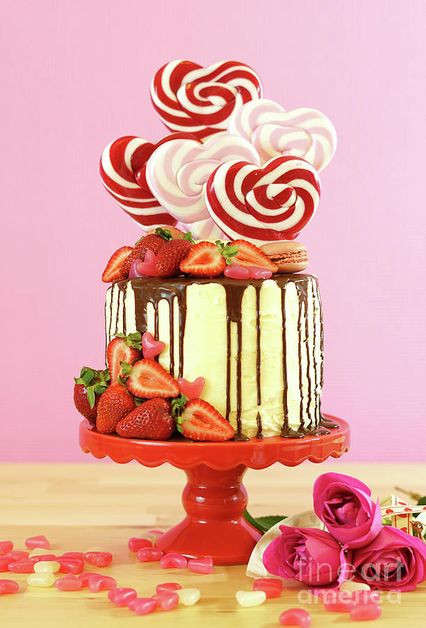 Valentines Day candyland drip cake decorated with heart shaped lollipops. #2 Photograph by Milleflore Images