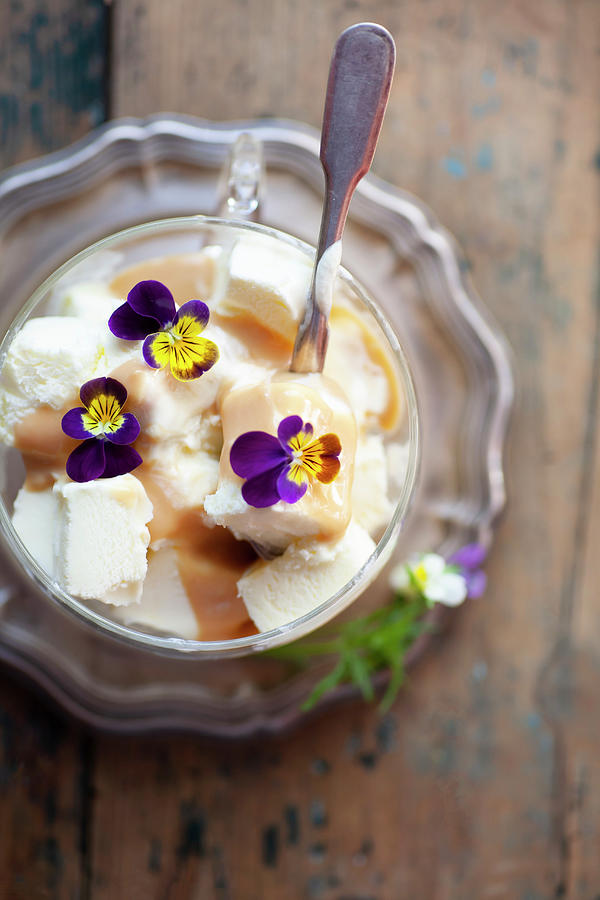 Vanilla Ice Cream With Caramel Sauce And Viola Flowers #2 Photograph by Alicja Koll