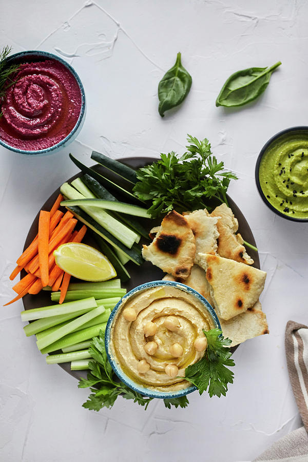 Various Types Of Hummus Served With Fresh Vegetables And Pita Bread #2 Photograph by Natasa Dangubic