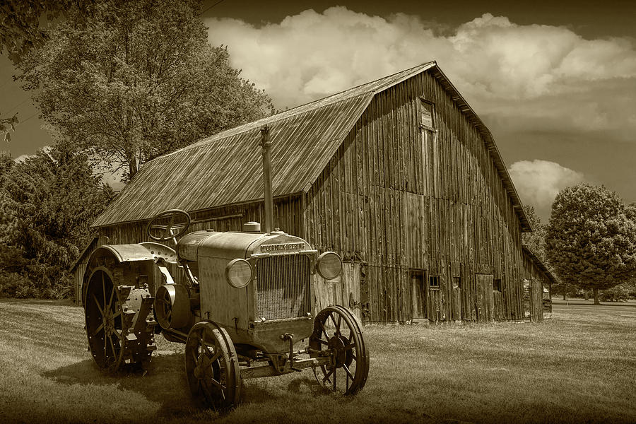 Vintage McCormick-Deering Tractor with old weathed Barn in a Rus #2 Photograph by Randall Nyhof