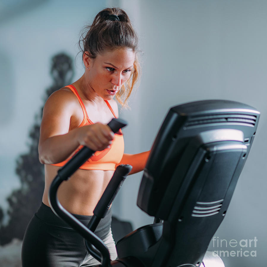 Woman Exercising On Elliptical Cross Trainer #2 Photograph by Microgen Images/science Photo Library