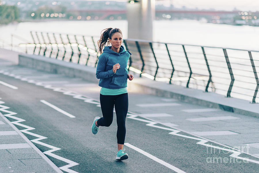 Woman Jogging In City #1 by Microgen Images/science Photo Library
