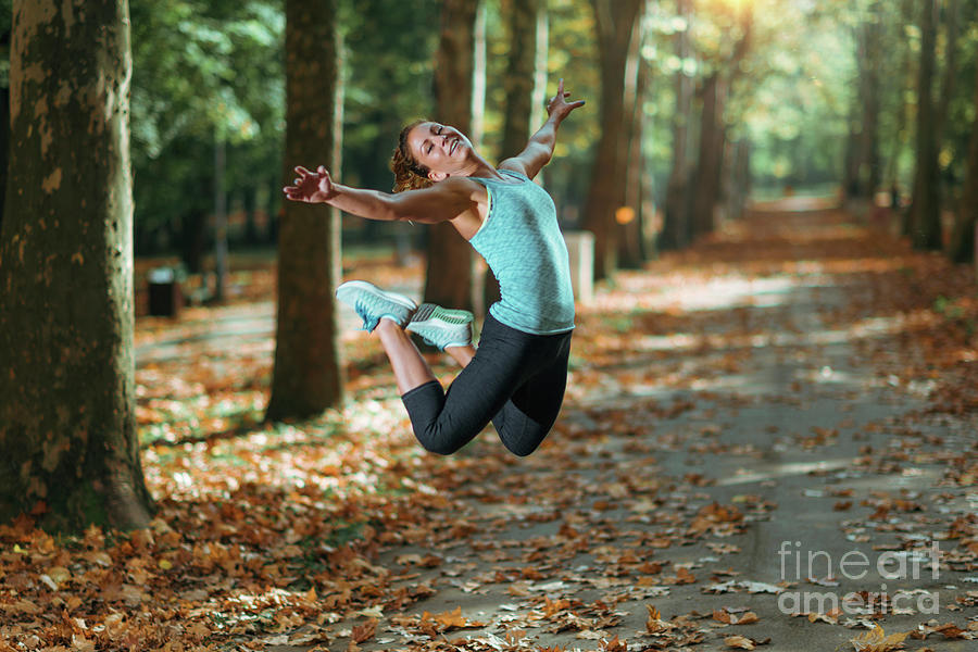 Woman Jumping Outdoors #2 Photograph by Microgen Images/science Photo Library