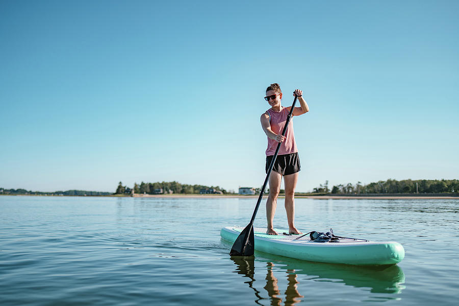 Woman On Stand-up Paddleboard On Ocean In Summer Photograph By Cavan 