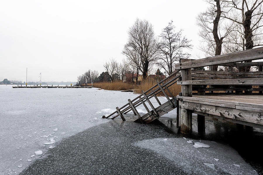 Wooden Stairs Leading Into A Frozen Lake Photograph