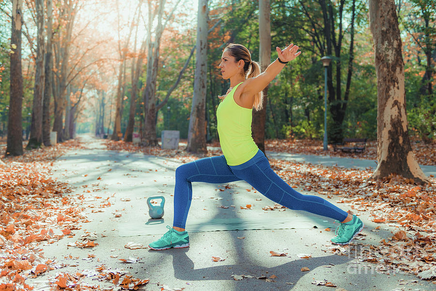 Woman Stretching In The Park Photograph by Microgen Images/science ...