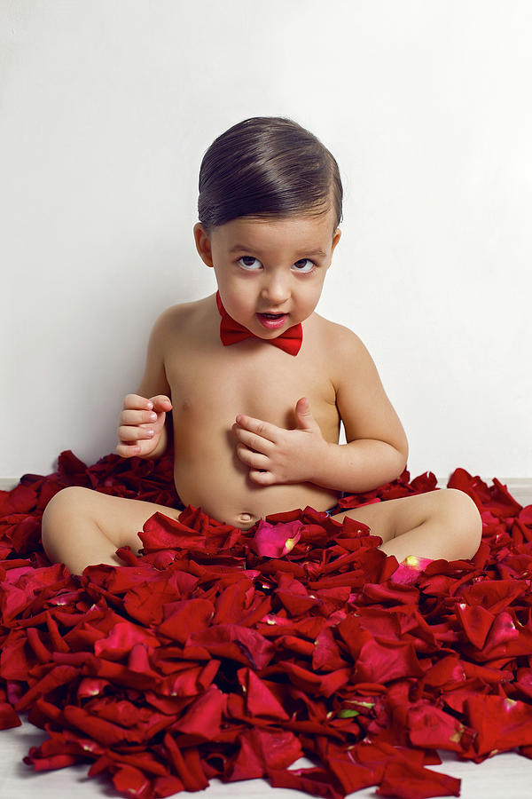 Baby Boy Sitting On White Floor With Petals Photograph