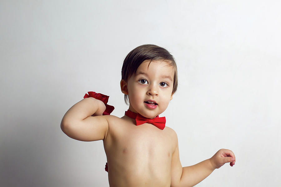 Child Without A T-shirt Sitting On A White Background Photograph