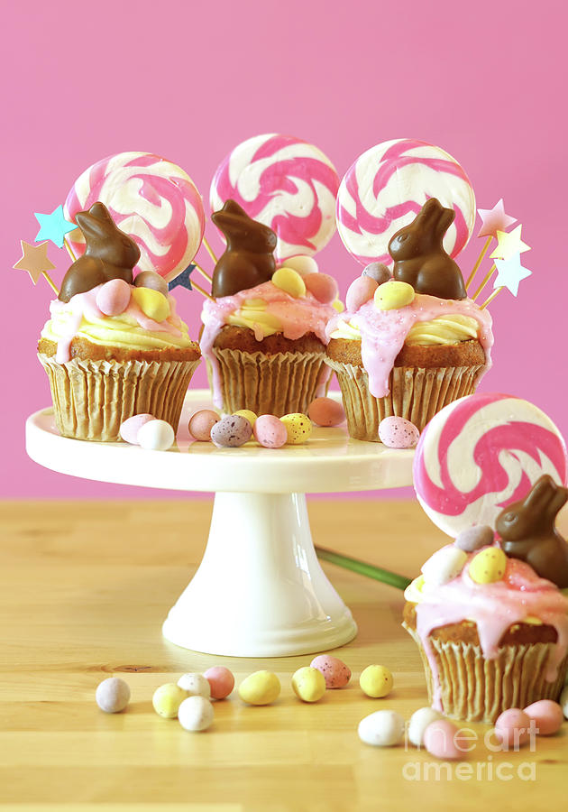 Easter theme candy land drip cupcakes in party table setting. Photograph by Milleflore Images