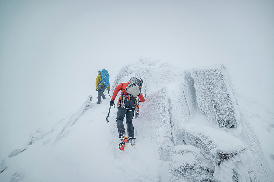 Ice Climbers Climbing A Frozen Alpine Ridge On A Mountain Photograph by ...