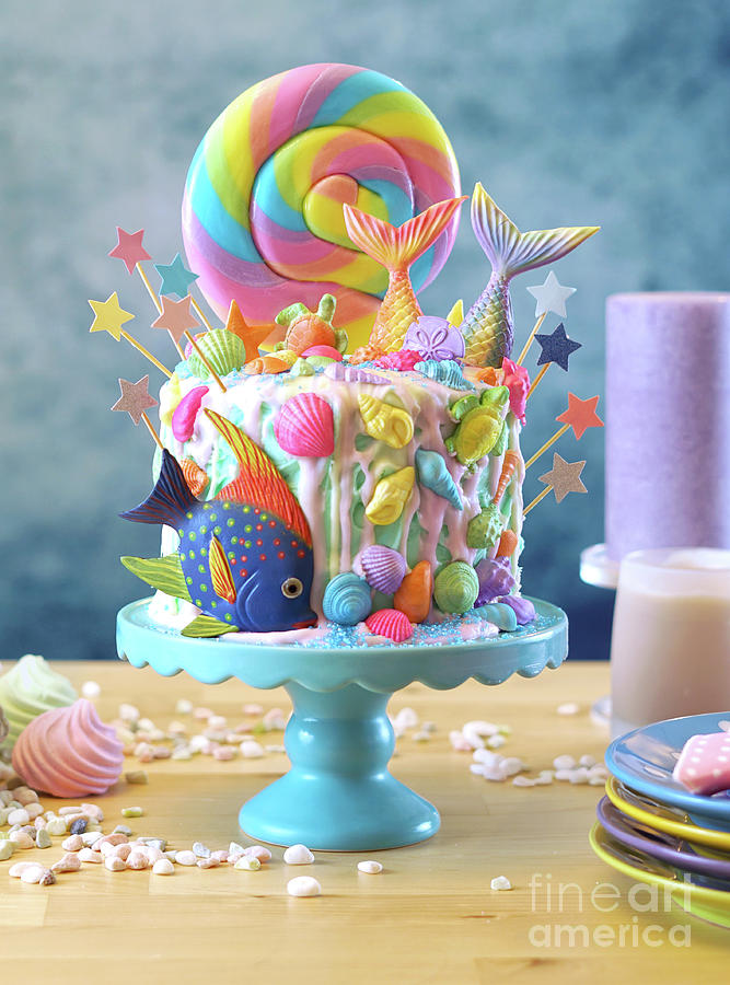 Mermaid theme candyland cake with glitter tails, shells and sea creatures. Photograph by Milleflore Images