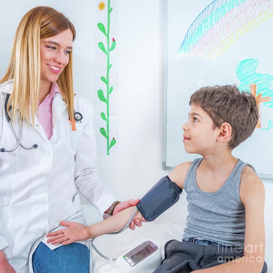 Paediatrician Measuring Boys Blood Pressure Photograph By Microgen