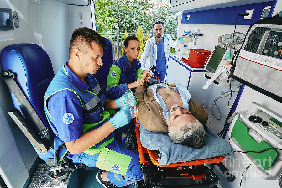 Patient Being Treated In The Back Of An Ambulance Photograph by ...