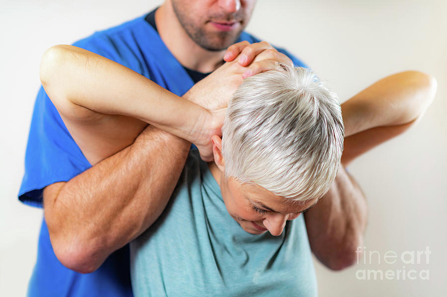 Physical Therapist Stretching Senior Womans Neck #3 Photograph by Microgen Images/science Photo Library