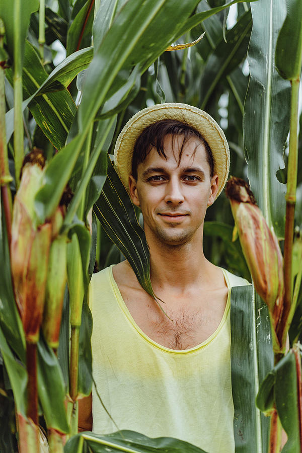 Portrait Of A Smiling Farm Man In A Hat In A Green Field. Photograph by ...