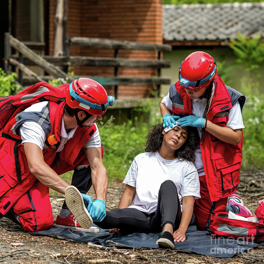 Rescue Team Helping Injured Woman Photograph by Microgen Images/science