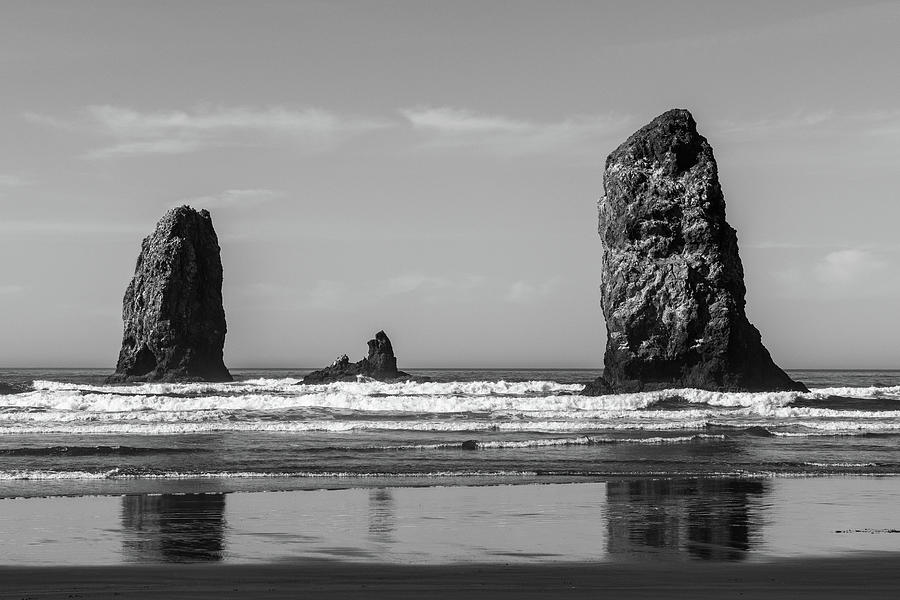 The Waves Crashing On Vertical Rocks Protruding In Cannon Beach, Oregon, Usa. Photograph