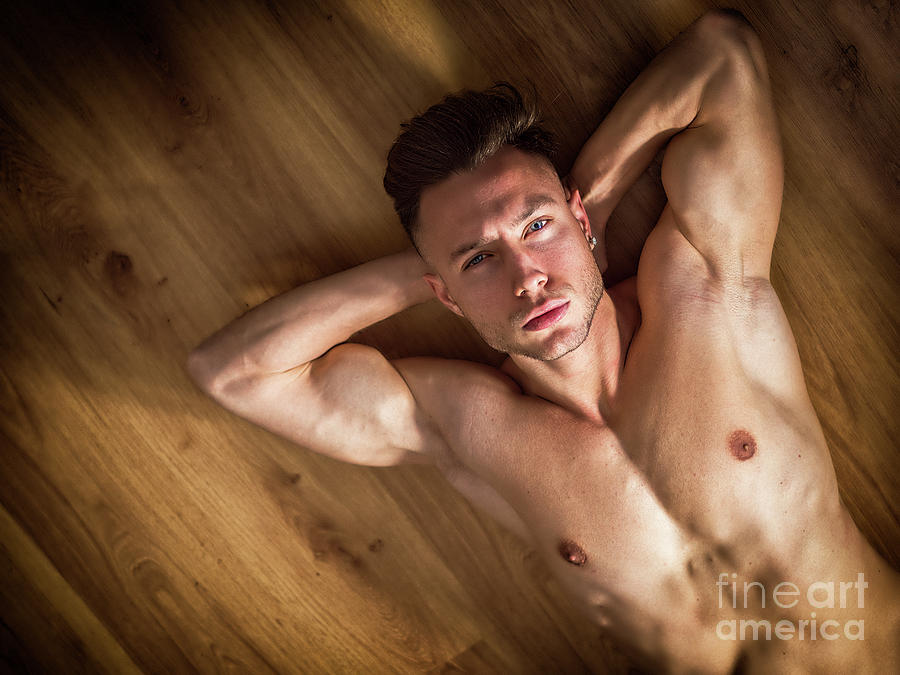 Totally naked muscular young man laying on floor by Stefano Cavoretto.