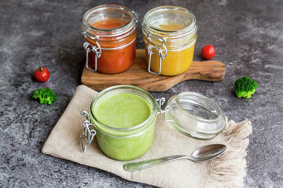 Various Colourful Soups In Glass Jars broccoli Soup, Tomato Soup, Pumpkin Soup #3 Photograph by Sandra Rsch