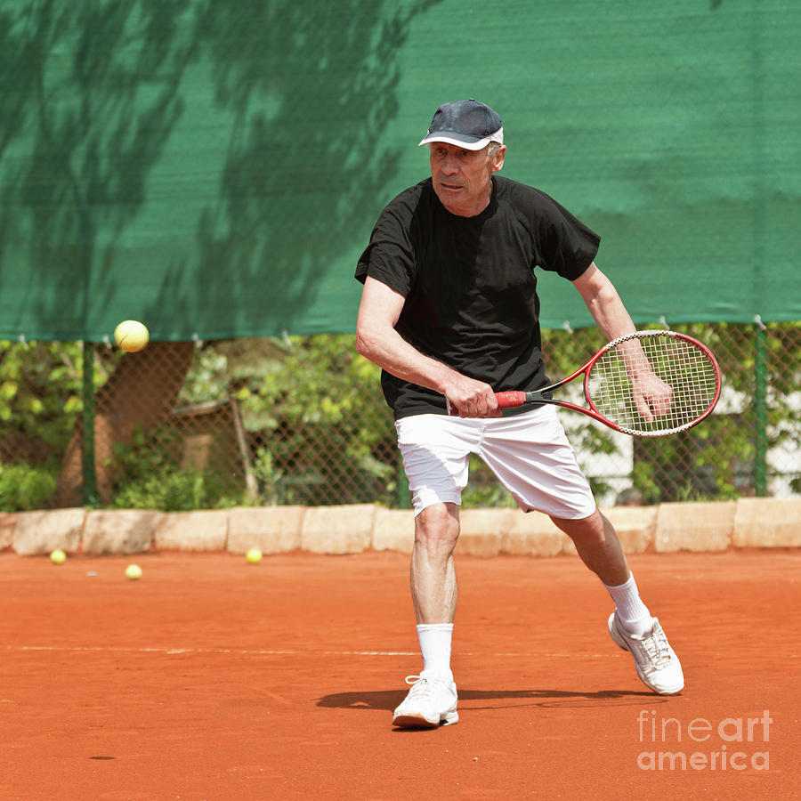 Active Senior Man Playing Tennis #4 Photograph by Microgen Images/science Photo Library