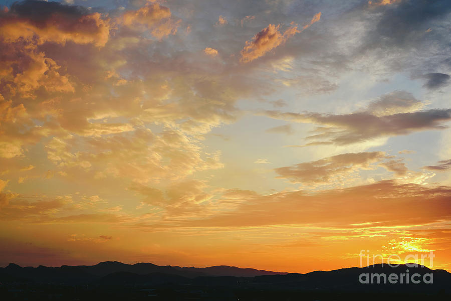 Beautiful sunset with the sun of orange tones behind the mountains and deep blue sky #4 Photograph by Joaquin Corbalan