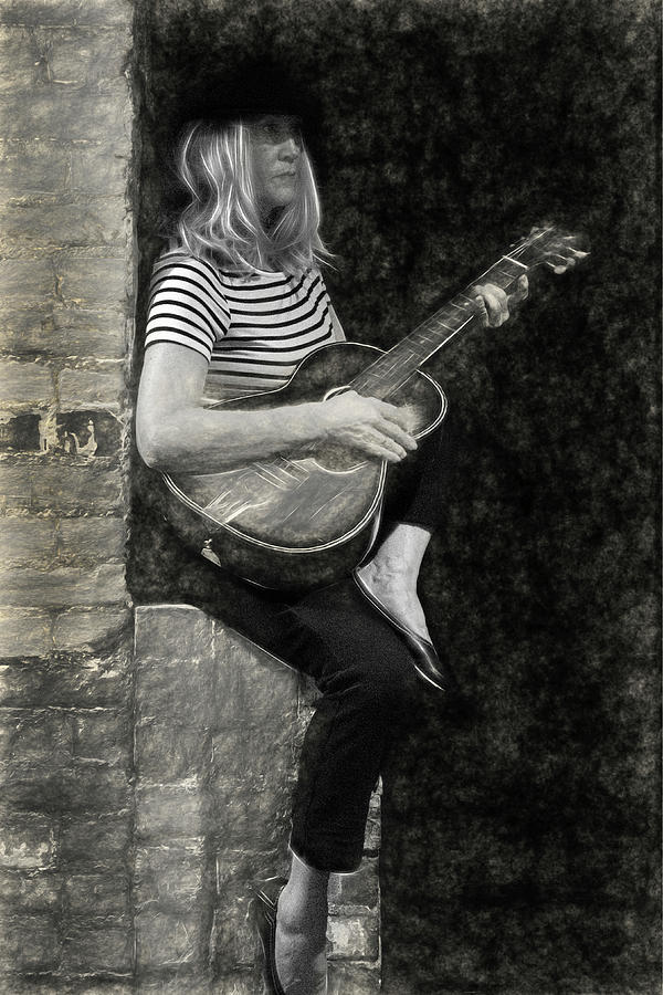 Blondie woman playing guitar sitting on a brick wall #4 Photograph by Dan Friend