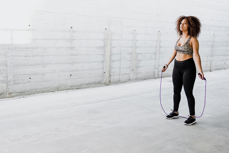 Curvy African American Woman Skipping Rope In Urban Area Photograph by ...