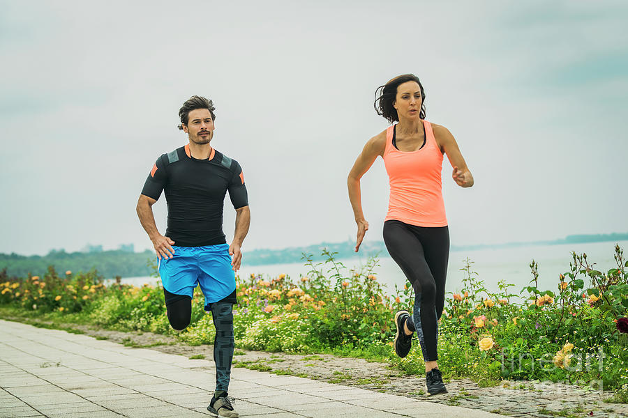 Fit Young Couple Jogging Outdoors Photograph by Microgen Images/science ...