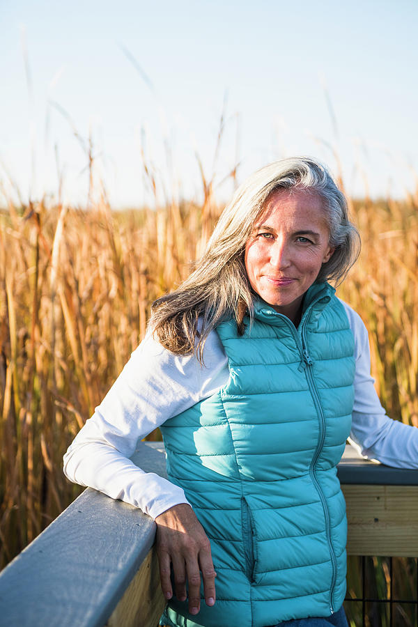 Gray Haired Woman Enjoying A Nature Walk In Golden Marsh Photograph by ...