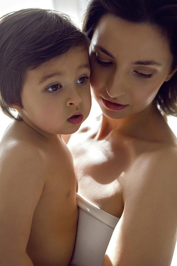Mother In A White T-shirt Holding Her Son In Her Arms Photograph