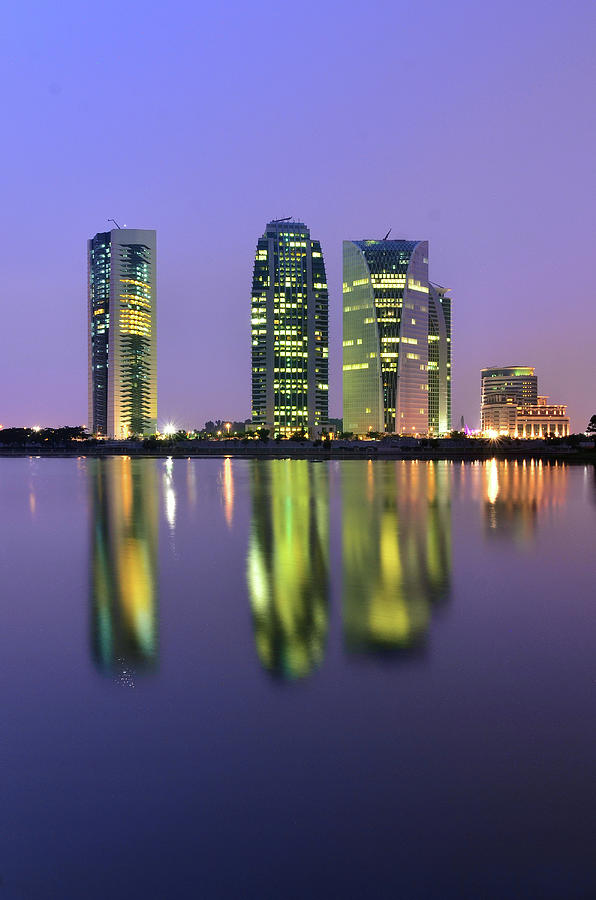 4 Skyscrapers Glow At Night Over The Photograph by Photography By Azrudin
