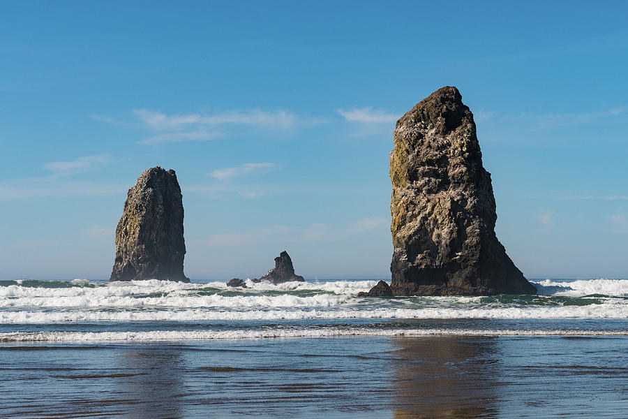 The Waves Crashing On Vertical Rocks Protruding In Cannon Beach, Oregon, Usa. Photograph