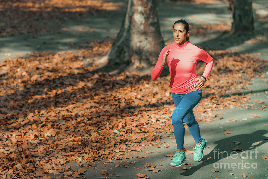 Woman Jogging In Public Park by Microgen Images/science Photo Library