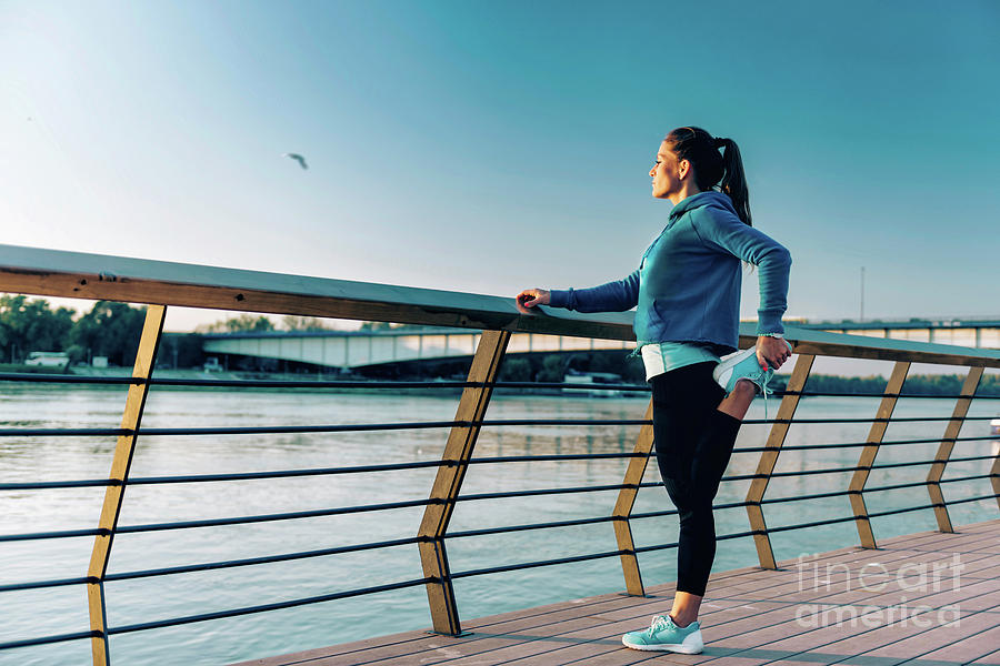 Woman Stretching On Bridge #4 Photograph by Microgen Images/science Photo Library