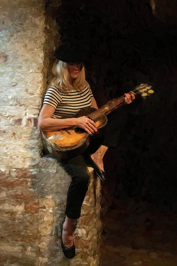 Blondie woman playing guitar sitting on a brick wall #5 Photograph by Dan Friend