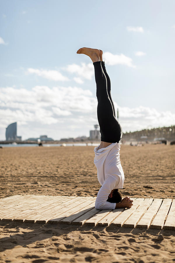 Barcelona Photograph - Man Doing Yoga On The Beach In Barcelona #5 by Cavan Images