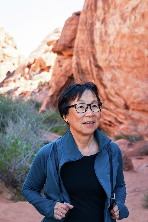 Nature Photograph - Portrait Of Senior Asian Woman Hiking In The Desert Landscape #5 by Cavan Images