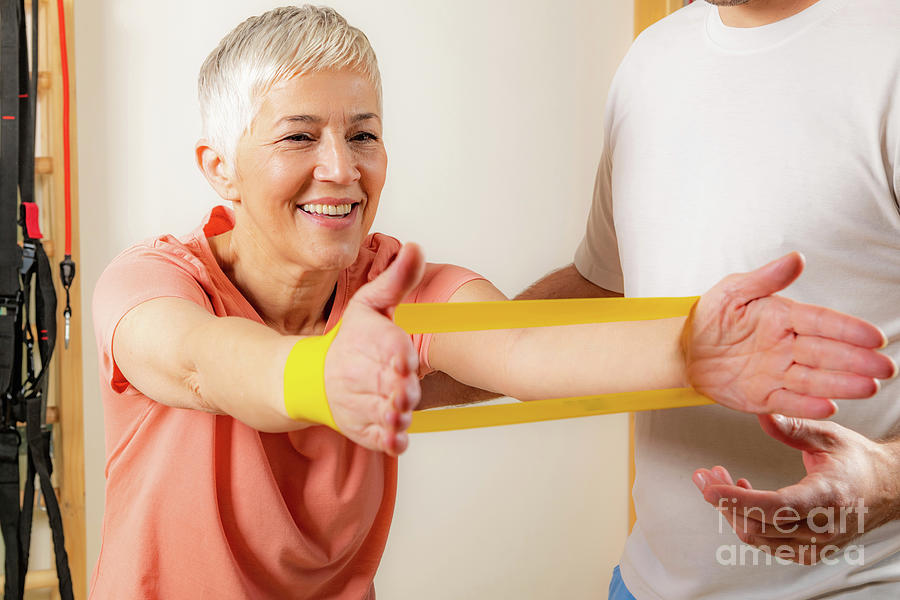 Senior Woman Exercising With Resistance Band #5 Photograph by Microgen Images/science Photo Library