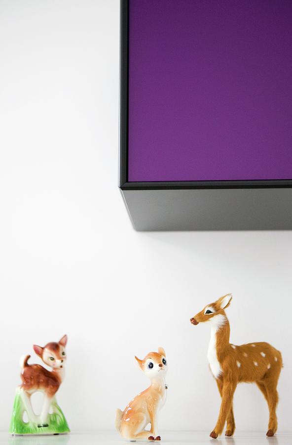 50s-style Animal Ornaments On Shelf Below Wall-mounted Cabinet Photograph by Annette Nordstrom