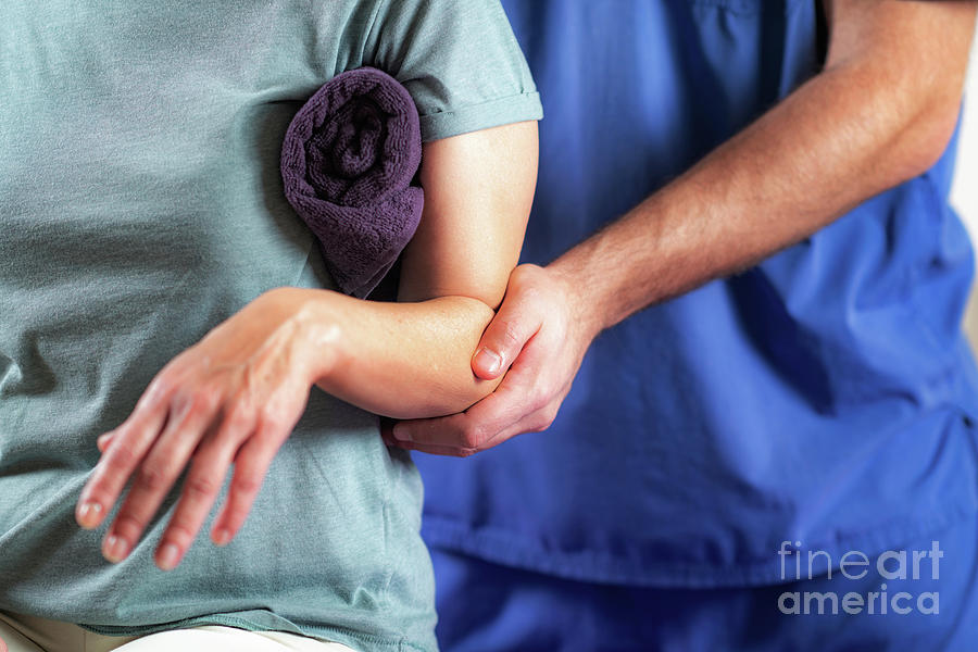 Physical Therapist Examining Patients Arm #6 Photograph by Microgen Images/science Photo Library