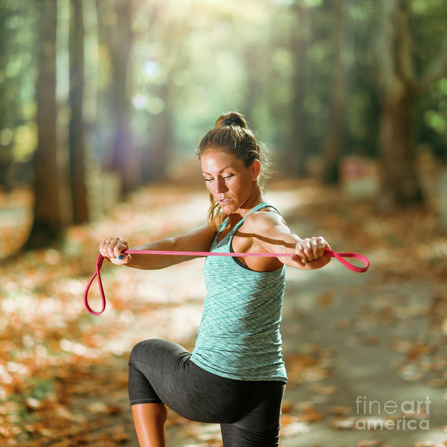 Woman Exercising With Elastic Band Outdoors #6 Photograph by Microgen Images/science Photo Library