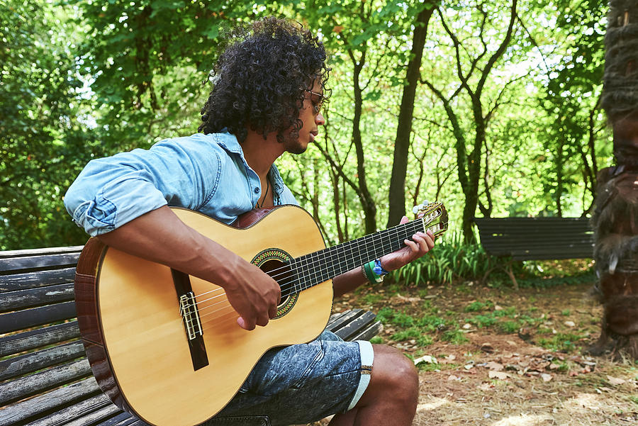 Music Photograph - Young Musician With Classical Guitar Playing Under The Shade Of Some Trees In A Park. #6 by Cavan Images