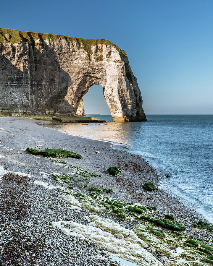 Chalk cliffs of Etretat with the natural arch called Manneporte ...