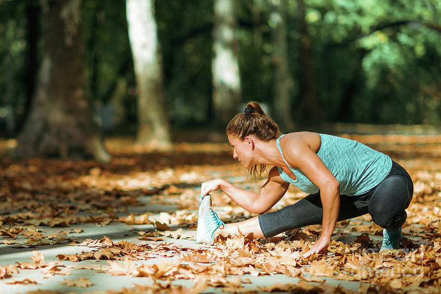 Woman Stretching In The Park #7 Photograph by Microgen Images/science Photo Library
