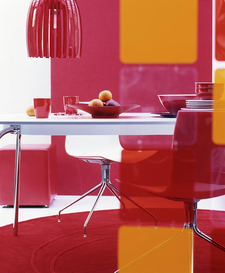 70s-style Dining Area In Shades Of Red And Orange Photograph by Matteo Manduzio