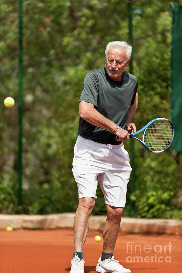 Active Senior Man Playing Tennis Photograph by Microgen Images/science Photo Library
