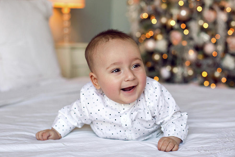 Baby Boy Six Months Lying On The Bed In A White Shirt Photograph by