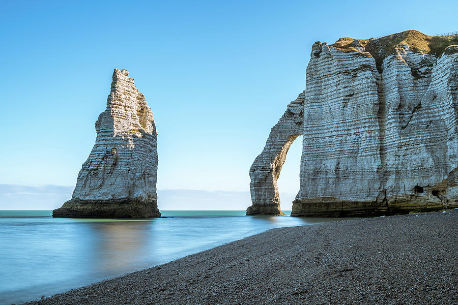 Chalk cliffs of Etretat with the natural arch Porte d'Aval and the ...