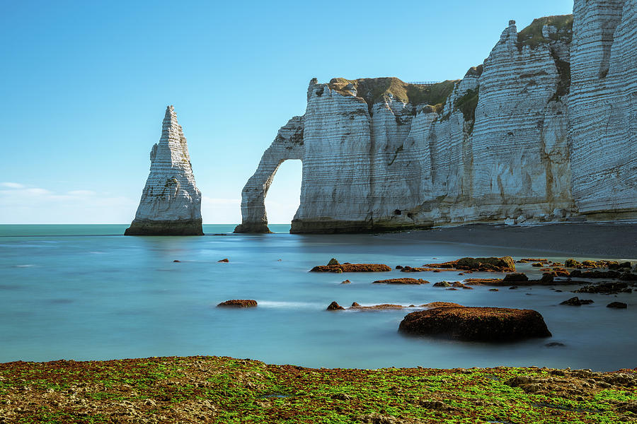 Chalk cliffs of Etretat with the natural arch Porte d'Aval and the ...