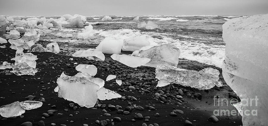 Giant ice blocks detached from icebergs on the coast of an Icelandic beach. #9 Photograph by Joaquin Corbalan